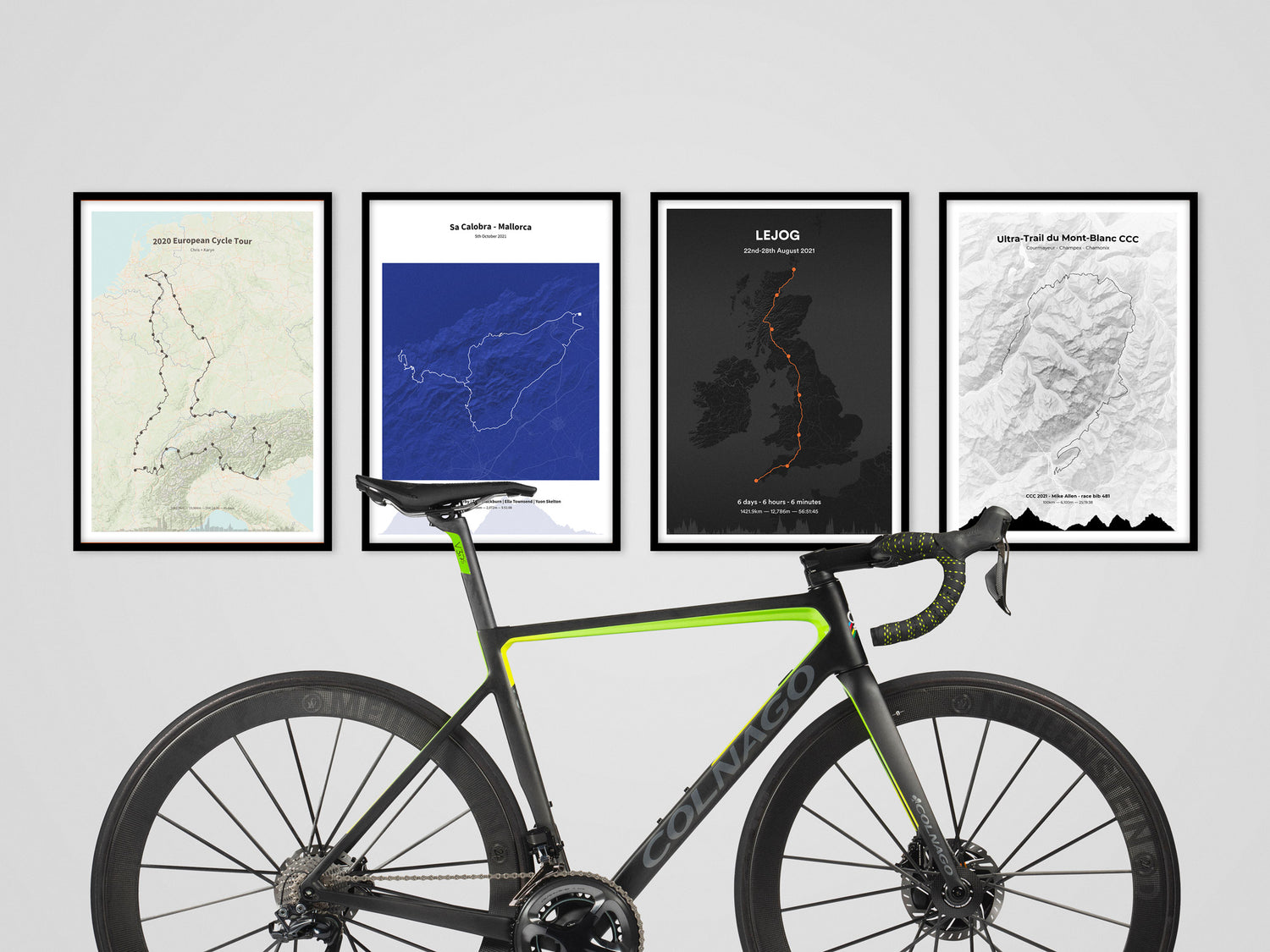 Framed cycling route map print above bike